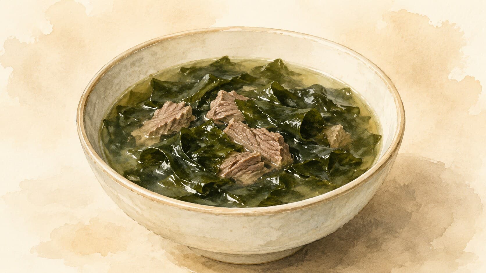 A brown ceramic bowl filled with clear pale brown broth, dark-green rehydrated miyeok strands, and small beef cubes, served with white rice.
