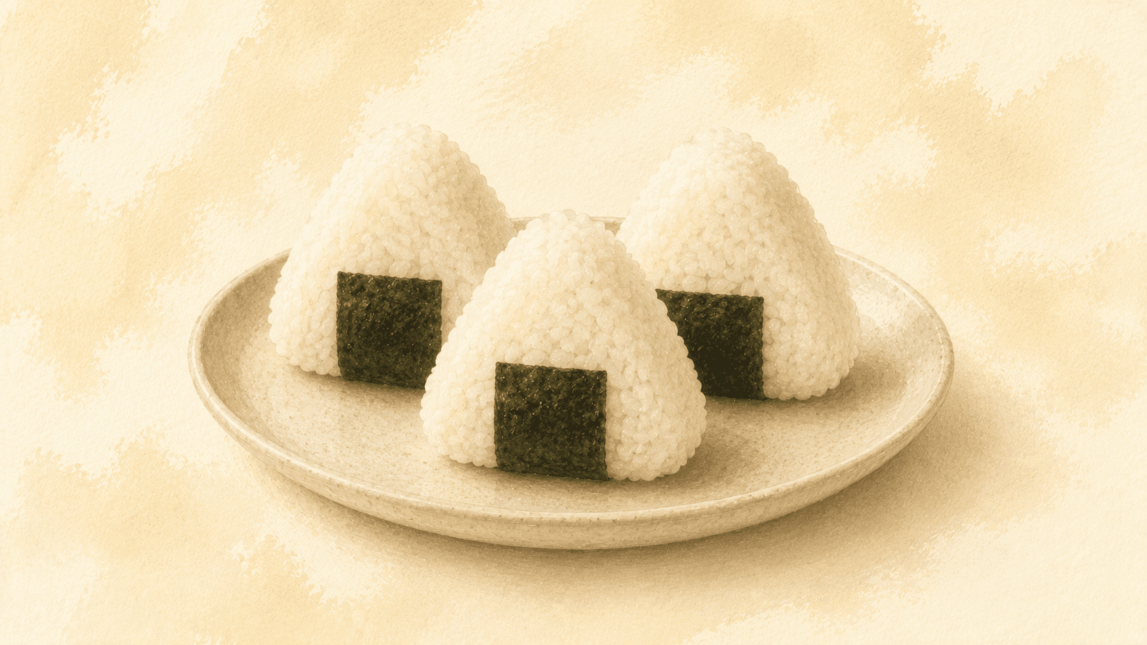 Two triangular onigiri on a dark wooden board, one wrapped in a band of nori, with visible salt crystals on the surface