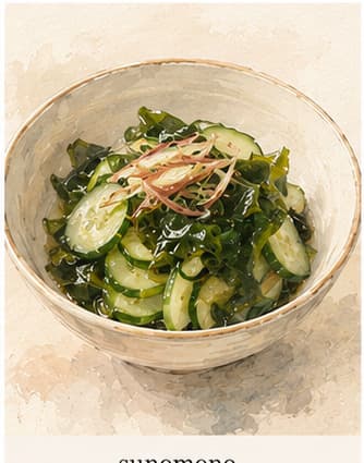 A small glass bowl of sunomono with thin cucumber slices, a few pieces of wakame seaweed, and a pale golden vinegar dressing